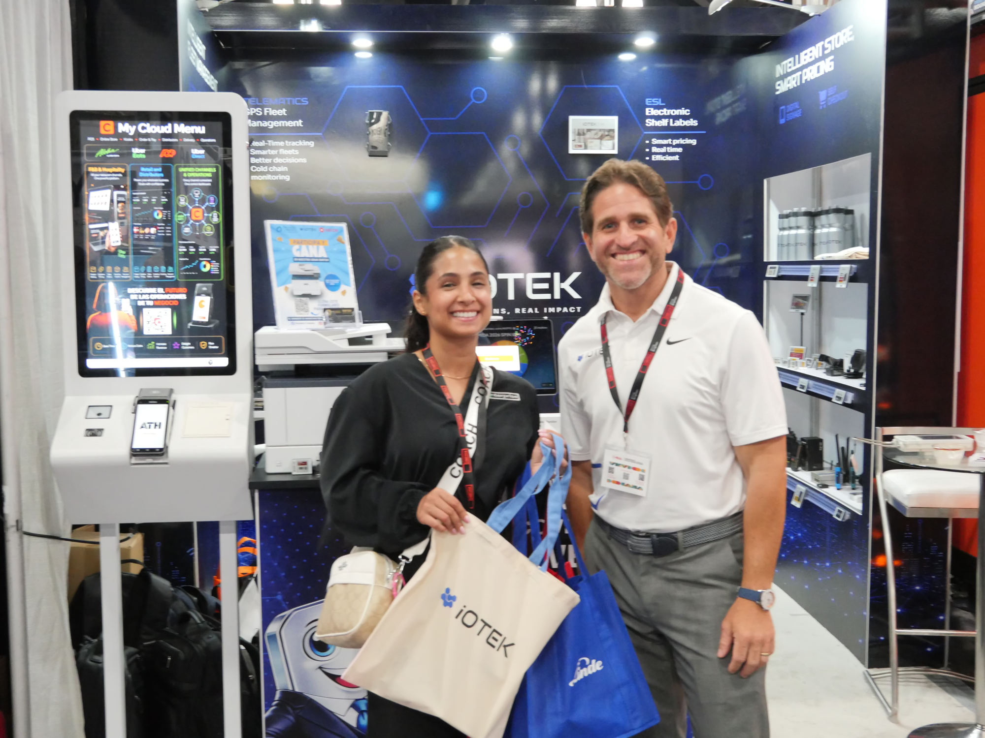 Visitors at the My Cloud Menu self-service kiosk at the iOTEK MIDA 2026 booth