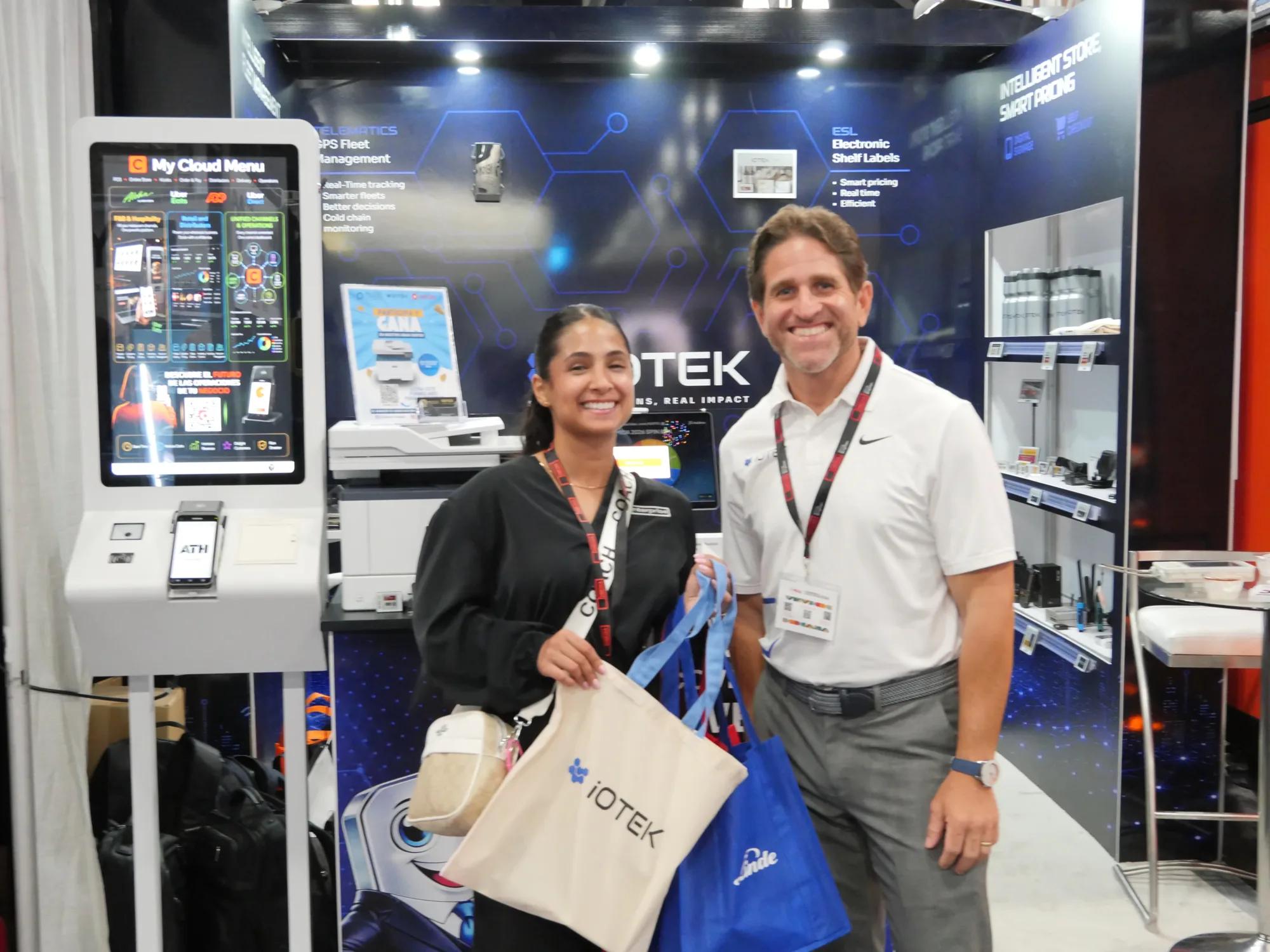 Visitors at the My Cloud Menu self-service kiosk at the iOTEK MIDA 2026 booth