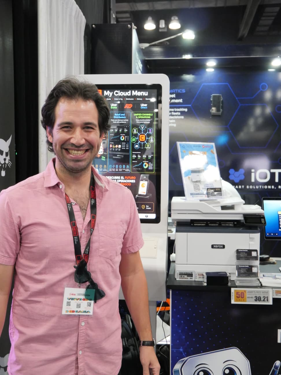 iOTEK team member at the MIDA 2026 booth next to the My Cloud Menu kiosk
